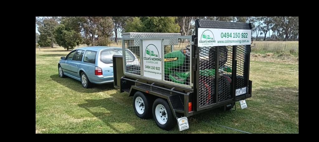 Colm's Mowing branded trailer and vehicle